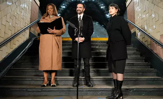 New York Attorney General Letitia James left, prepares to administer the oath of office to mayor-elect Zohran Mamdani as Rama Duwaji, looks on, Wednesday, Dec. 31, 2025, in New York. (AP Photo/Yuki Iwamura)