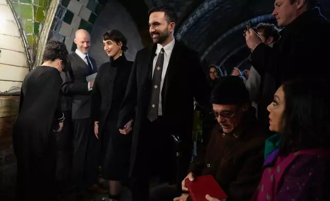 Mayor-elect Zohran Mamdani, center, arrives with his wife Rama Duwaji for a swearing-in ceremony, Wednesday, Dec. 31, 2025, in New York. (AP Photo/Yuki Iwamura)