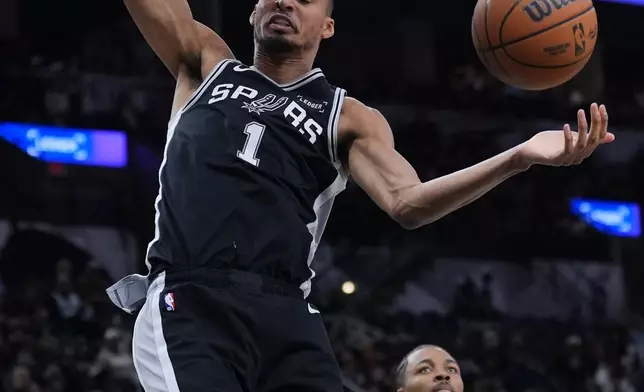 San Antonio Spurs forward Victor Wembanyama (1) scores past New Orleans Pelicans forward Trey Murphy III (25) during the second half of an NBA basketball game in San Antonio, Sunday, Jan. 25, 2026. (AP Photo/Eric Gay)