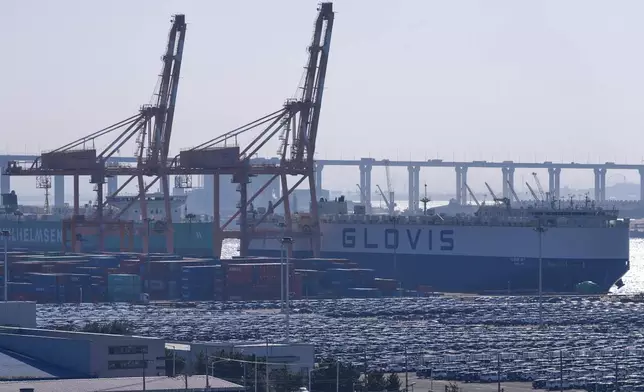 Vehicles for export are parked and shipping containers are seen at a port in Pyeongtaek, South Korea, Tuesday, Jan. 27, 2026. (AP Photo/Lee Jin-man)