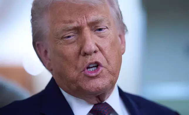 President Donald Trump speaks with reporters aboard Air Force One after leaving the World Economic Forum in Davos for Washington, Thursday, Jan. 22, 2026. (AP Photo/Evan Vucci)