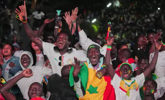 Fans celebrate Senegal's goal in the Africa Cup of Nations final soccer match between Senegal and Morocco in Dakar, Senegal, Sunday, Jan. 18, 2026. (AP Photo/Misper Apawu)