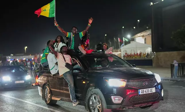 Fans celebrate after Senegal won the Africa Cup of Nations in Dakar, Senegal, Sunday, Jan. 18, 2026. (AP Photo/Misper Apawu)