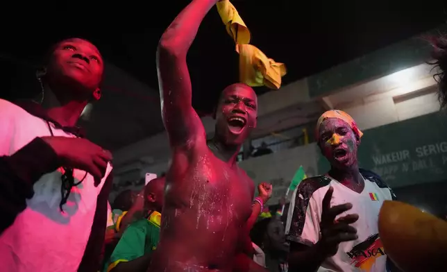 Fans celebrate Senegal's victory of the Africa Cup of Nations final soccer match between Senegal and Morocco in Dakar, Senegal, Sunday, Jan. 18, 2026. (AP Photo/Misper Apawu)