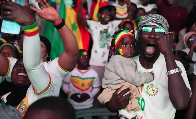 Fans celebrate Senegal's victory of the Africa Cup of Nations final soccer match between Senegal and Morocco in Dakar, Senegal, Sunday, Jan. 18, 2026. (AP Photo/Misper Apawu)