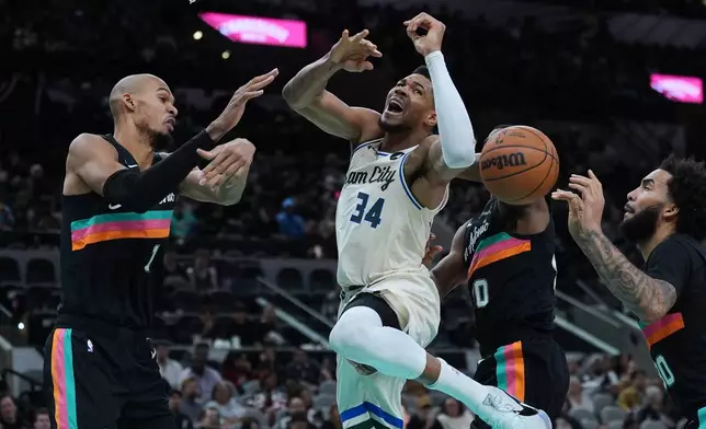Milwaukee Bucks forward Giannis Antetokounmpo (34) is blocked as he drives to the basket against San Antonio Spurs forward Victor Wembanyama (1) during the second half of an NBA basketball game in San Antonio, Thursday, Jan. 15, 2026. (AP Photo/Eric Gay)