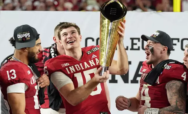 Indiana quarterback Fernando Mendoza holds the trophy after their win against Miami in the College Football Playoff national championship game, Monday, Jan. 19, 2026, in Miami Gardens, Fla. (AP Photo/Lynne Sladky)