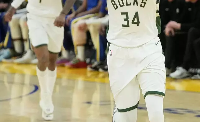 Milwaukee Bucks forward Giannis Antetokounmpo (34) gestures after making a 3-point basket against the Golden State Warriors during the second half of an NBA basketball game in San Francisco, Wednesday, Jan. 7, 2026. (AP Photo/Jeff Chiu)