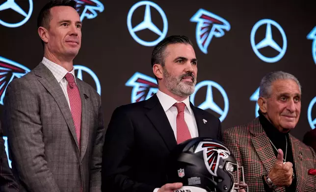 Atlanta Falcons' President of Football Matt Ryan, head coach Kevin Stefanski, owner Arthur Blank, from left, pose for a photo during a NFL Atlanta Falcons news conference, Tuesday, Jan. 27, 2026, in Atlanta. (AP Photo/Mike Stewart)