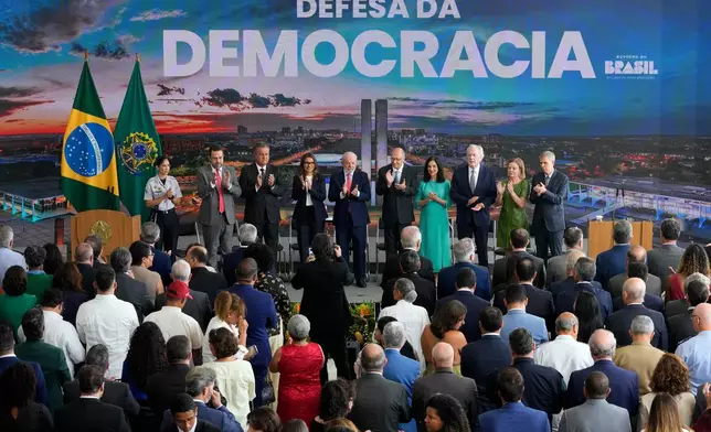 Brazilian President Luiz Inacio Lula da Silva, center, and his wife, first lady Rosangela da Silva, attend a ceremony marking the three year anniversary of a failed attempt to overthrow Brazil’s democratic system, at Planalto presidential palace in Brasilia, Brazil, Thursday, Jan. 8, 2026. (AP Photo/Eraldo Peres)