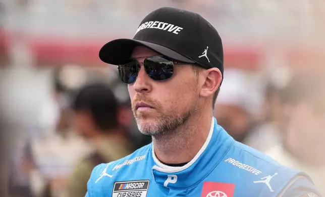 FILE - Denny Hamlin looks on prior to a NASCAR Cup Series auto race at Charlotte Motor Speedway, Sunday, Oct. 5, 2025, in Concord, N.C. (AP Photo/Matt Kelley, File)