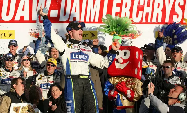 FILE - Jimmie Johnson celebrates his win in victory lane at NASCAR's UAW-DaimlerChrysler 400 at the Las Vegas Motor Speedway, March 12, 2006. (AP Photo/Eric Jamison, File)