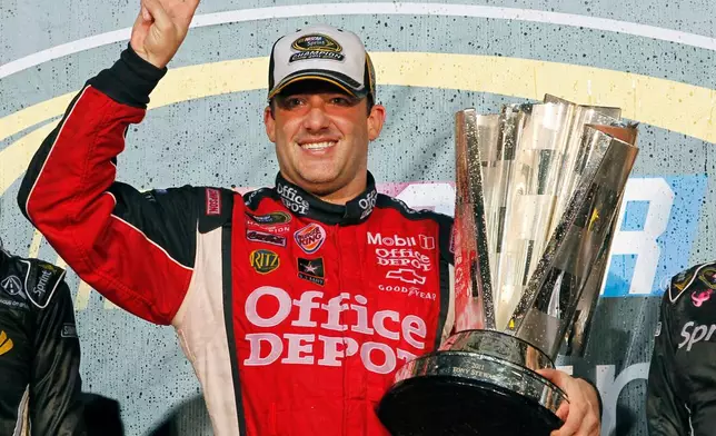 FILE - In this Nov. 20, 2011 file photo, Tony Stewart celebrates after winning his third NASCAR Sprint Cup Series championship, at Homestead-Miami Speedway in Homestead, Fla. (AP Photo/Terry Renna, File)