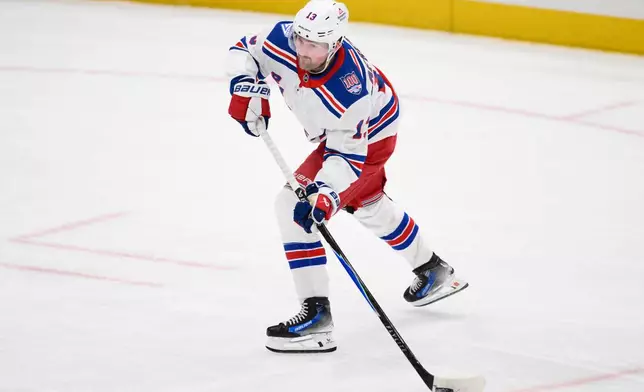 New York Rangers left wing Alexis Lafrenière (13) skates with the puck during the third period of an NHL hockey game against the Washington Capitals, Wednesday, Dec. 31, 2025, in Washington. (AP Photo/Nick Wass)