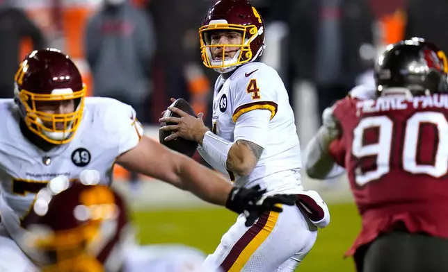 FILE - Washington Football Team quarterback Taylor Heinicke (4) looks to pass against the Tampa Bay Buccaneers during the second half of an NFL wild-card playoff football game, Jan. 9, 2021, in Landover, Md. (AP Photo/Julio Cortez, File)