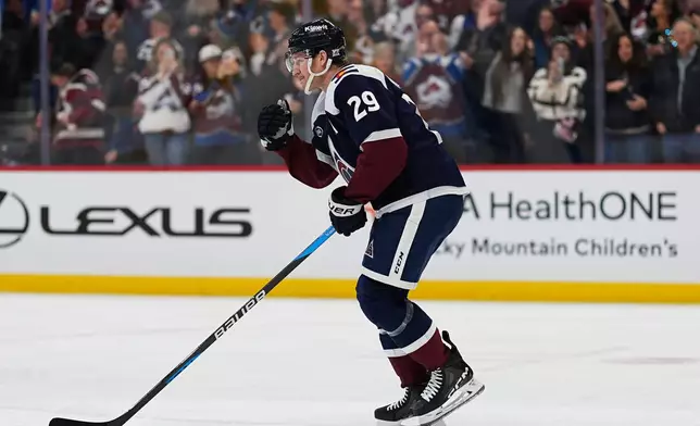 Colorado Avalanche center Nathan MacKinnon celebrates as he skates back to the team box after scoring a goal against the St. Louis Blues in the first period of an NHL hockey game Wednesday, Dec. 31, 2025, in Denver. (AP Photo/David Zalubowski)