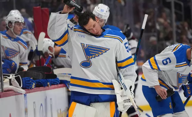St. Louis Blues goaltender Jordan Binnington cools down during a time out in the first period of an NHL hockey game against the Colorado Avalanche, Wednesday, Dec. 31, 2025, in Denver. (AP Photo/David Zalubowski)