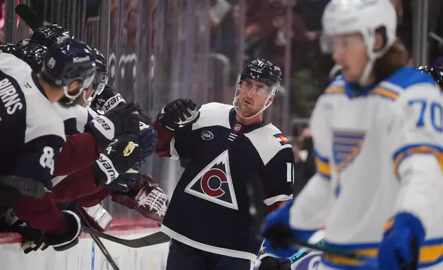 Colorado Avalanche center Brock Nelson is congratulated as he passes the team box after scoring a goal against the St. Louis Blues in the second period of an NHL hockey game, Wednesday, Dec. 31, 2025, in Denver. (AP Photo/David Zalubowski)