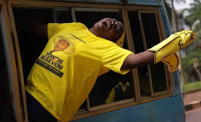 A supporter of Uganda's President and National Resistance Movement (NRM) presidential candidate Yoweri Museveni reacts during a campaign rally in Kampala, Uganda, Tuesday, Jan. 13, 2026. (AP Photo/Samson Otieno)