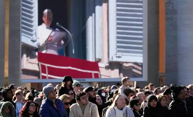 Faithful listen to Pope Leo XIV's Angelus noon prayer in St. Peter's Square at the Vatican, Sunday, Jan. 11, 2026. (AP Photo/Gregorio Borgia)