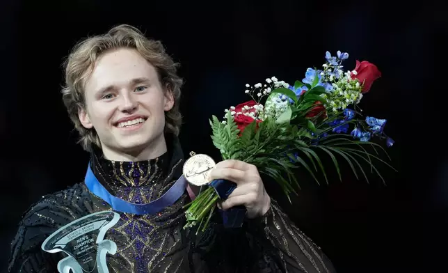 Gold medalist Ilia Malinin poses with his medal during the men's free skate competition at the U.S. Figure Skating Championships, Saturday, Jan. 10, 2026, in St. Louis. (AP Photo/Stephanie Scarbrough)