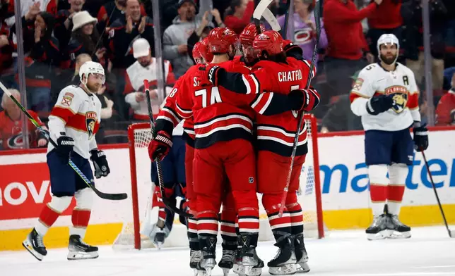 Carolina Hurricanes celebrate after a goal by Nikolaj Ehlers during the first period of an NHL hockey game against the Florida Panthers in Raleigh, N.C., Friday, Jan. 16, 2026. (AP Photo/Karl DeBlaker)