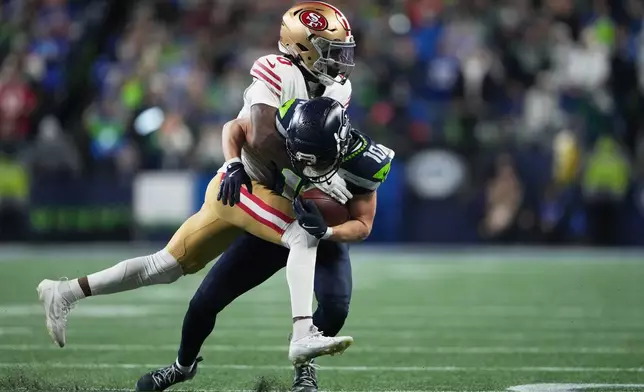 Seattle Seahawks wide receiver Cooper Kupp (10) makes a reception against San Francisco 49ers cornerback Renardo Green (0) during the second half of an NFL football divisional playoff game Saturday, Jan. 17, 2026, in Seattle. (AP Photo/Lindsey Wasson)