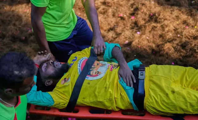 Medical personnel evacuate an injured participant from the arena during the Jallikattu bull-taming event at the annual harvest festival called Pongal in Avaniyapuram village on the outskirts of Madurai, India, Thursday, Jan. 15, 2026. (AP Photo/Mahesh Kumar A.)