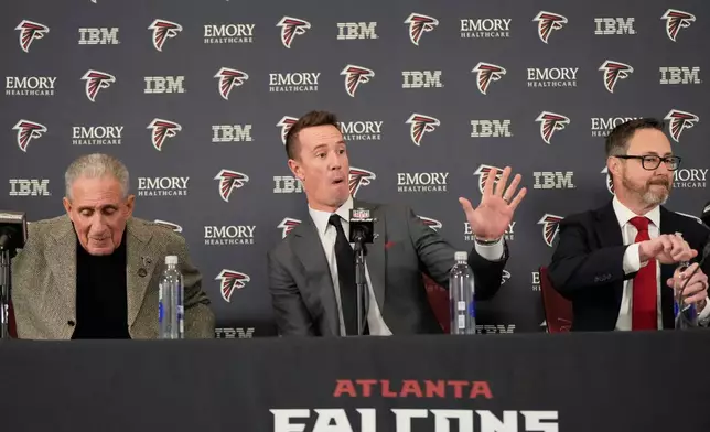 Former Falcons quarterback Matt Ryan gestures during a news conference as the new Atlanta Falcons president of football along with Atlanta Falcons owner Arthur Blank, left, and President and CEO of the Atlanta Falcons Greg Beadles, right, Tuesday, Jan. 13, 2026, in Flowery Branch, Ga. (AP Photo/Brynn Anderson)
