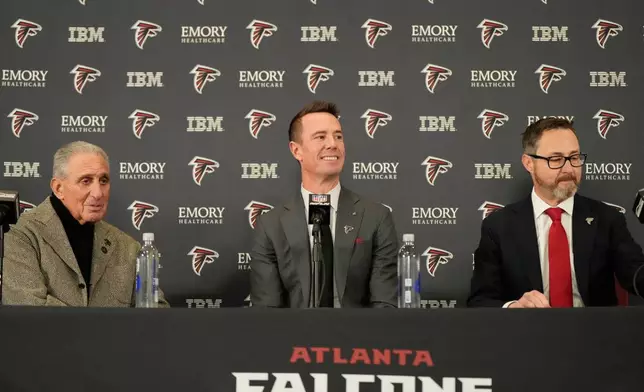 Former Falcons quarterback Matt Ryan speaks during a news conference as the new Atlanta Falcons president of football along with Atlanta Falcons owner Arthur Blank, left, and President and CEO of the Atlanta Falcons Greg Beadles, right, Tuesday, Jan. 13, 2026, in Flowery Branch, Ga. (AP Photo/Brynn Anderson)