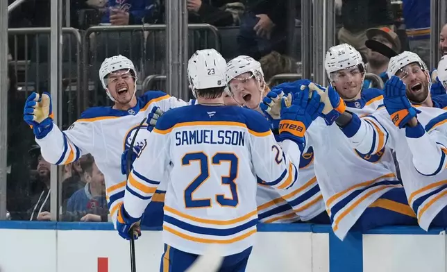 Buffalo Sabres' Mattias Samuelsson (23) celebrates with teammates after scoring a goal during the third period of an NHL hockey game against the New York Rangers Thursday, Jan. 8, 2026, in New York. (AP Photo/Frank Franklin II)