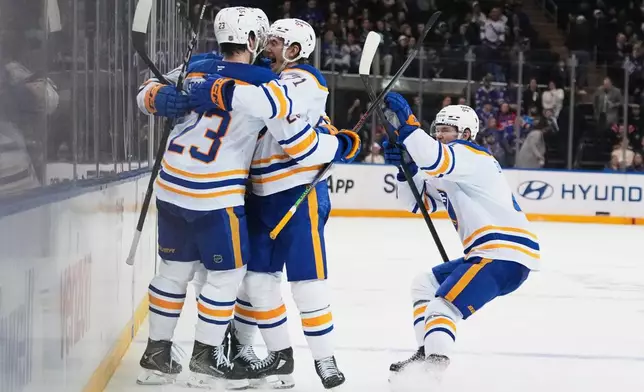 Buffalo Sabres' Mattias Samuelsson (23) celebrates with teammates after scoring a goal during the third period of an NHL hockey game against the New York Rangers Thursday, Jan. 8, 2026, in New York. (AP Photo/Frank Franklin II)