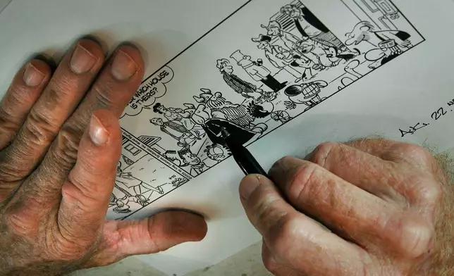 FILE - Dean Young, writer of the"Blondie" comic strip, draws in his studio in Clearwater, Fla., July 12, 2005. (AP Photo/Robert Azmitia, File)