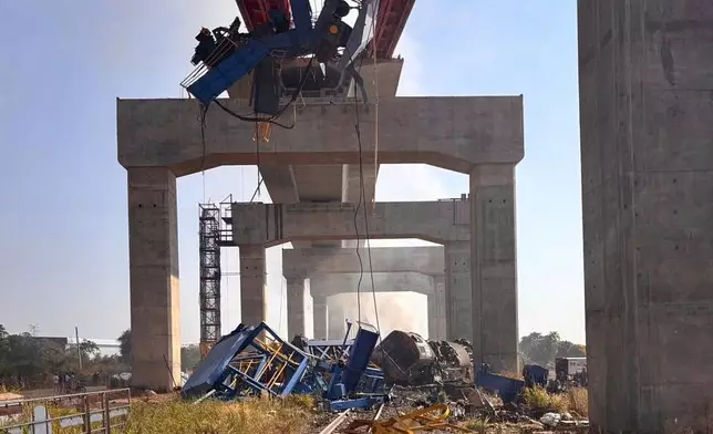 This photo released from State Railway of Thailand, shows a scene after a construction crane fell into a passenger train in Nakhon Ratchasima province, Thailand Wednesday, Jan. 14, 2026. (State Railway of Thailand via AP)