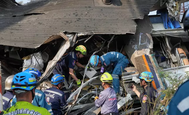Rescuers work amid the wreckage after a construction crane fell into a passenger train in Nakhon Ratchasima province, Thailand, Wednesday, Jan.14, 2026. (AP Photo/Sakchai Lalit))