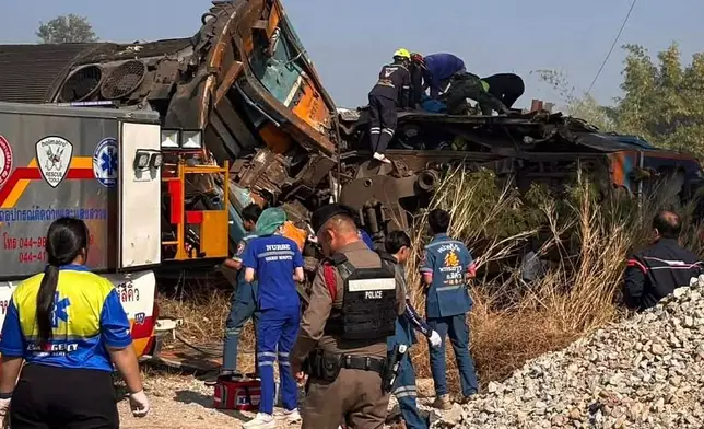 This photo released from State Railway of Thailand, shows aid workers after a construction crane fell into a passenger train in Nakhon Ratchasima province, Thailand Wednesday, Jan. 14, 2026. (State Railway of Thailand via AP)