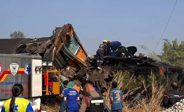 This photo released from State Railway of Thailand, shows aid workers after a construction crane fell into a passenger train in Nakhon Ratchasima province, Thailand Wednesday, Jan. 14, 2026. (State Railway of Thailand via AP)