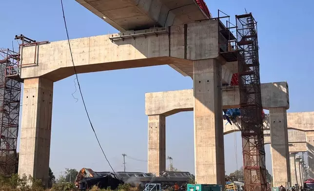 This photo provided by State Railway of Thailand shows a scene after a construction crane fell into a passenger train in Nakhon Ratchasima province, Thailand Wednesday, Jan. 14, 2026. (State Railway of Thailand via AP)