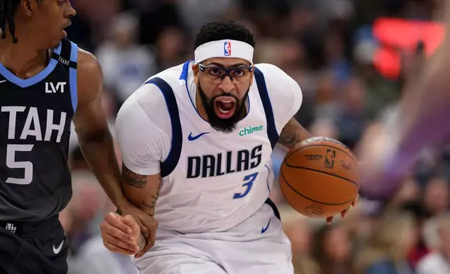 Dallas Mavericks forward Anthony Davis (3) drives to the basket while guarded by Utah Jazz forward Cody Williams (5) during the first half of an NBA basketball game, Thursday, Jan. 8, 2026, in Salt Lake City. (AP Photo/Tyler Tate)