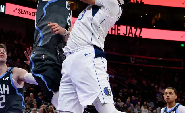 Utah Jazz forward Lauri Markkanen, center left, blocks the shot of Dallas Mavericks forward Anthony Davis, center right, during the first half of an NBA basketball game, Thursday, Jan. 8, 2026, in Salt Lake City. (AP Photo/Tyler Tate)