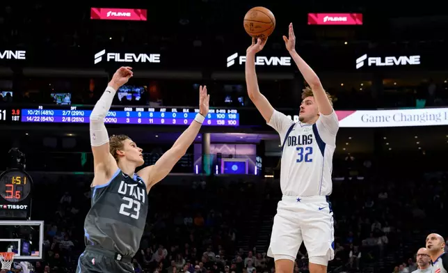 Dallas Mavericks forward Cooper Flagg (32) shoots over Utah Jazz forward Lauri Markkanen (23) during the first half of an NBA basketball game, Thursday, Jan. 8, 2026, in Salt Lake City. (AP Photo/Tyler Tate)
