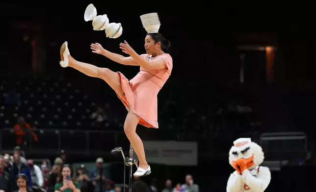 Red Panda performs as Miami's mascot Sebastian the Ibis looks on during halftime of an NCAA college basketball game between Miami and Stanford in Coral Gables, Fla., Wednesday, Jan. 28, 2026. (AP Photo/Rebecca Blackwell)