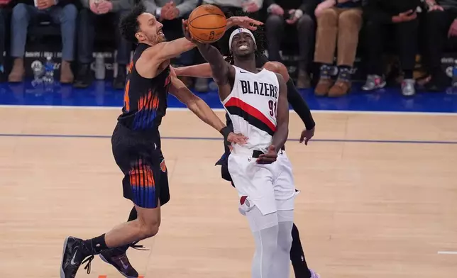 New York Knicks' Landry Shamet, left, defends a shot by Portland Trail Blazers' Sidy Cissoko during the second half of an NBA basketball game Friday, Jan. 30, 2026, in New York. (AP Photo/Frank Franklin II)