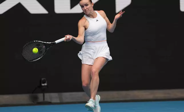 Elina Svitolina of Ukraine plays a forehand return to Linda Klimovicova of Poland during their second round match at the Australian Open tennis championship in Melbourne, Australia, Wednesday, Jan. 21, 2026. (AP Photo/Aaron Favila)
