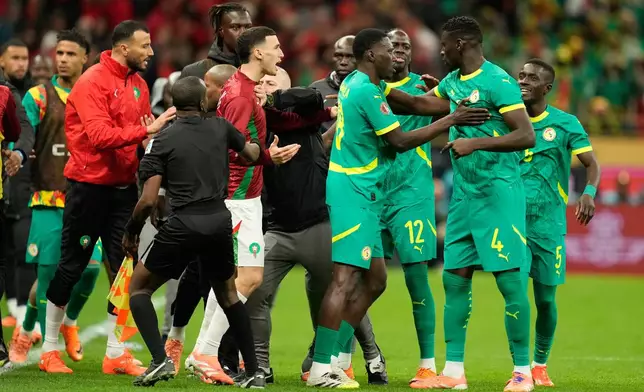 Senegal's and Morocco[s players scuffle after a penalty call during the Africa Cup of Nations final soccer match between Senegal and Morocco, in Rabat, Morocco, Sunday, Jan. 18, 2026. (AP Photo/Mosa'ab Elshamy)