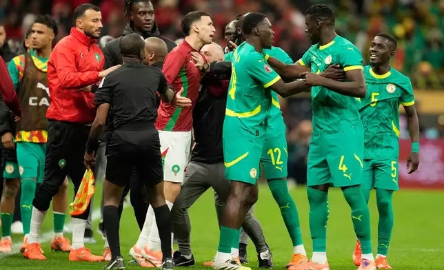 Senegal's and Morocco[s players scuffle after a penalty call during the Africa Cup of Nations final soccer match between Senegal and Morocco, in Rabat, Morocco, Sunday, Jan. 18, 2026. (AP Photo/Mosa'ab Elshamy)