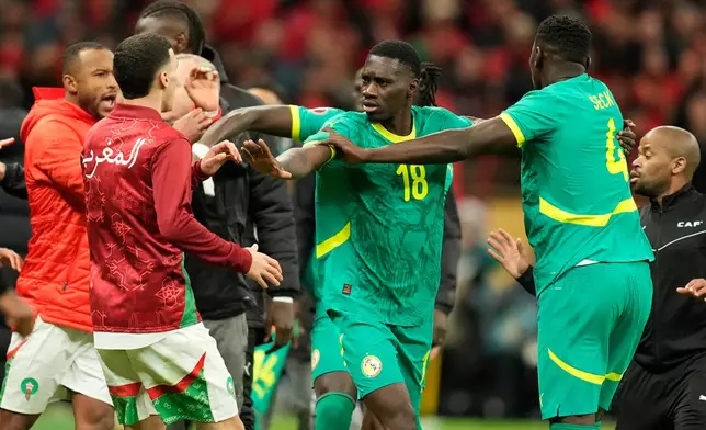 Senegal's and Morocco[s players scuffle after a penalty call during the Africa Cup of Nations final soccer match between Senegal and Morocco, in Rabat, Morocco, Sunday, Jan. 18, 2026. (AP Photo/Mosa'ab Elshamy)