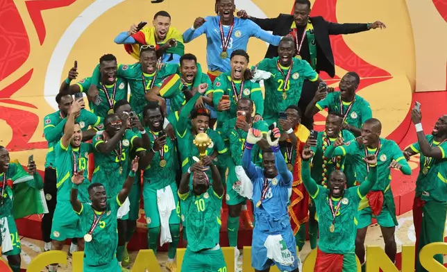 Senegal's Sadio Mane holds the trophy aloft as he celebrates with teammates after winning the Africa Cup of Nations final soccer match between Senegal and Morocco in Rabat, Morocco, Sunday, Jan. 18, 2026. (AP Photo/Youssef Loulidi)
