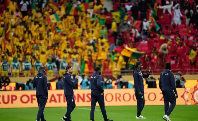 Senegal players walk onto the pitch before the Africa Cup of Nations final soccer match between Senegal and Morocco, in Rabat, Morocco, Sunday, Jan. 18, 2026. (AP Photo/Mosa'ab Elshamy)