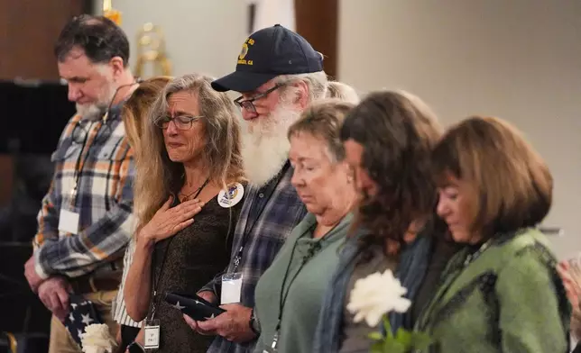 Attendees pray during a commemoration on the one-year anniversary of the Palisades Fire in the Pacific Palisades neighborhood of Los Angeles Wednesday, Jan. 7, 2026. (AP Photo/Jae C. Hong)